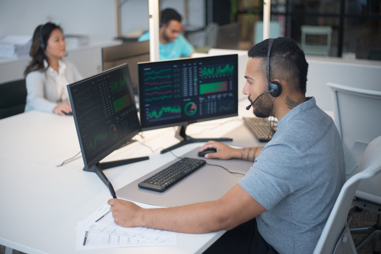 journey Team of customer service professionals working with headsets and computers in a modern office.